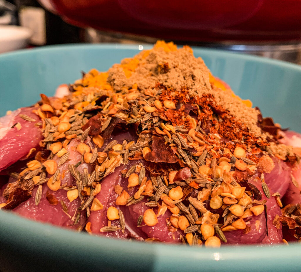 add the spices to the pork